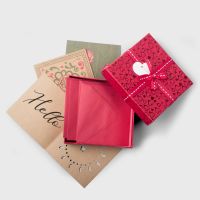 kraft brown and pink shipping packages with address and shipping labels on gray background