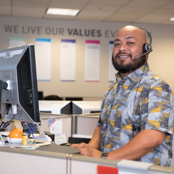 Avery employee at desk with headset on