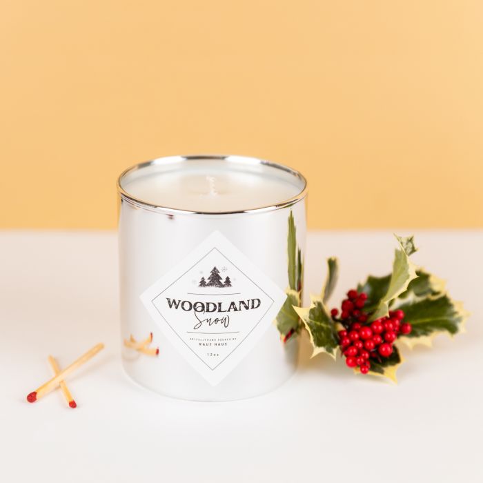 Woodland snow scented holiday candle with an Avery 2" square label on a silver tumbler jar from candlescience