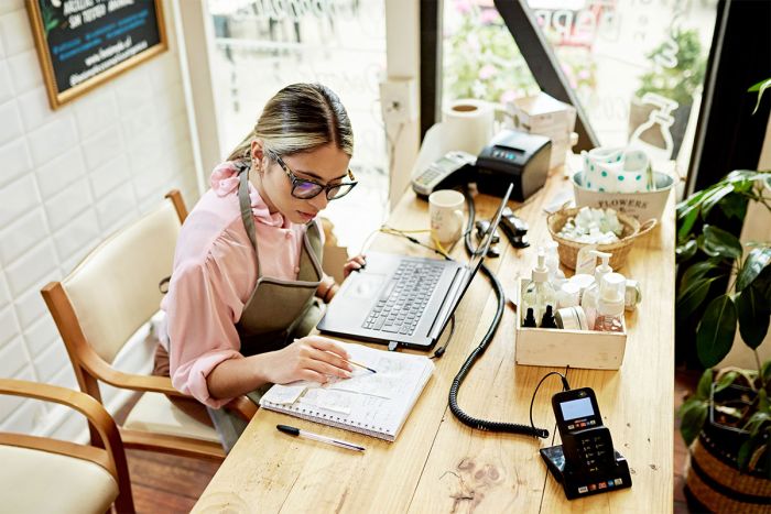 Woman updating her finances for her small business at year's end