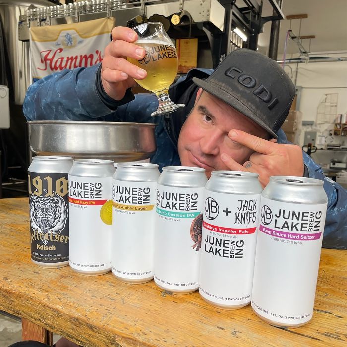 justin walsh owner of June lake brewing a June lake brewery with cans of beer