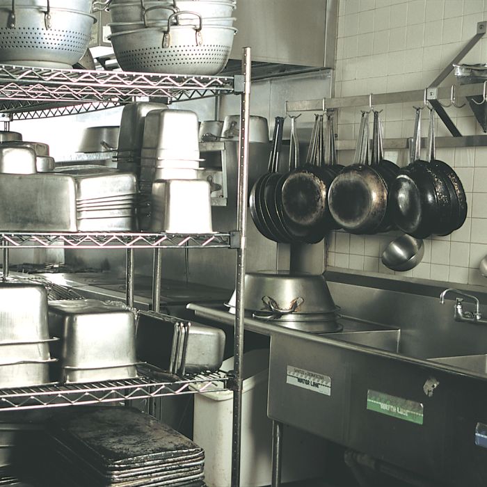 Hang pots and pans for better kitchen organization in commercial kitchens and at home.