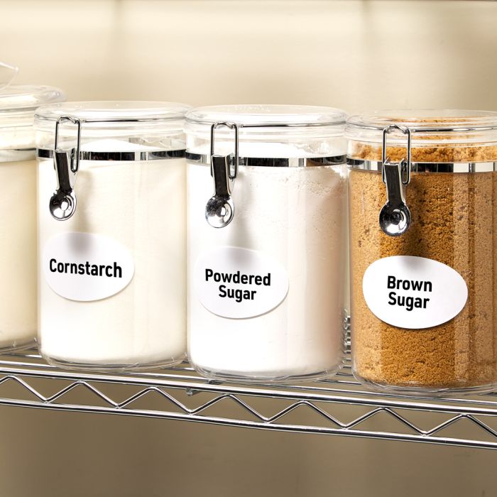 Stainless steel racks in a commercial kitchen featuring baking items like cornstarch, powdered sugar and brown sugar
