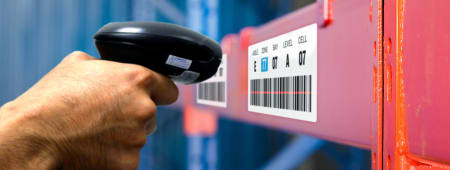 worker scanning barcode labels in a warehouse
