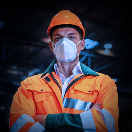 worker in construction gear wearing face mask