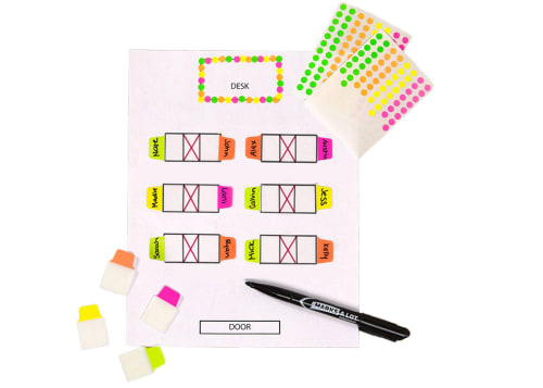 Flatlay image of laminated reading log with color coding tabs in various boxes on the chart