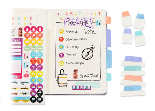 Flatlay of a colorful, bright planner with various sparkly, pastel ultra tabs inside and sitting next to it