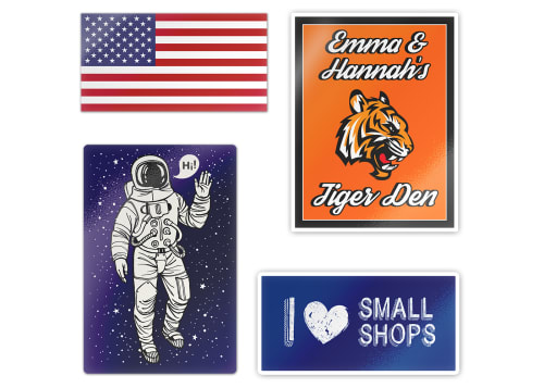 Four custom printed stickers with various designs- an American flag, a tiger logo, an astronaut, and an 'I heart small shops' one