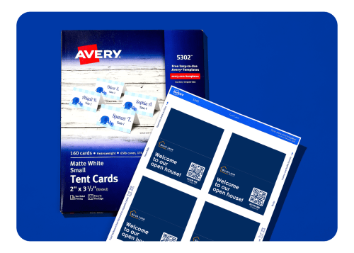 A pack of Avery tent cards next to a sheet of custom printed tent cards with real estate branding.