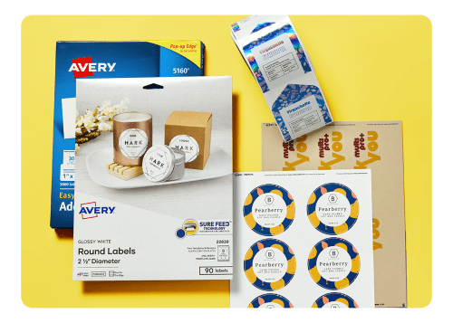 Packaged Avery labels along with custom-printed label sheets and rolls on a yellow background.