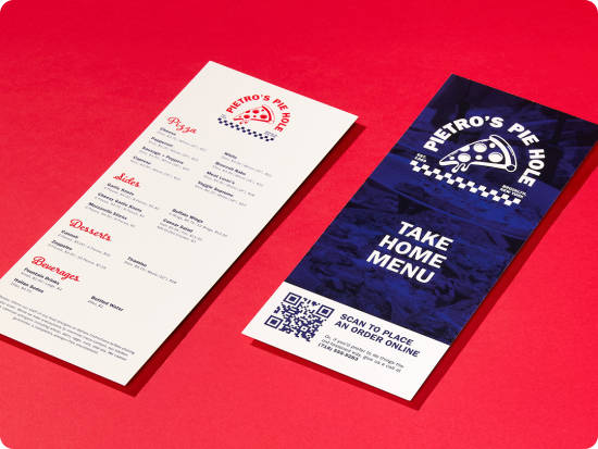 Diagonal view of two tall rack cards, featuring a menu for a pizza restaurant, on a bright red background