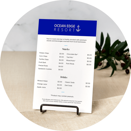 A beachside hotel mini-bar menu card featuring a list of snacks and beverage options.