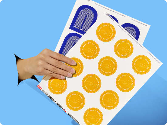 Custom Sheet Labels professionally printed with circular product branding designs; custom product labels for small business shown on blue background.