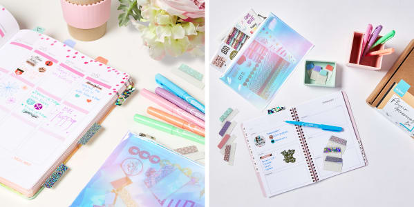 A beautiful planner decorated with colorful stickers, pastel markers and sparkling repositionable tabs on a white desk