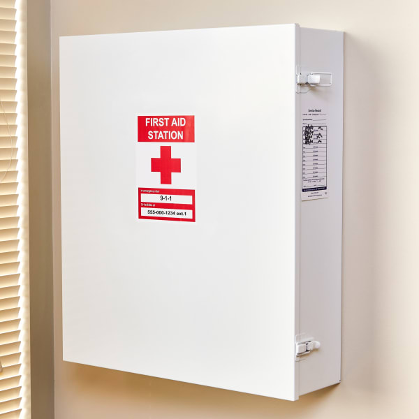 A metal wall-mounted first-aid kit with a 5 by 7 inch Avery Surface Safe label 61519 bearing the standard red medical cross and the words "First Aid Station."