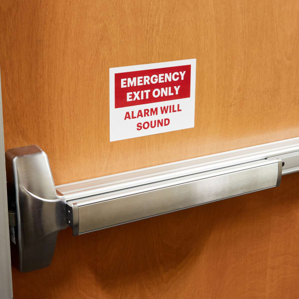 Adhesive Emergency Exit label shown on an office building door. 