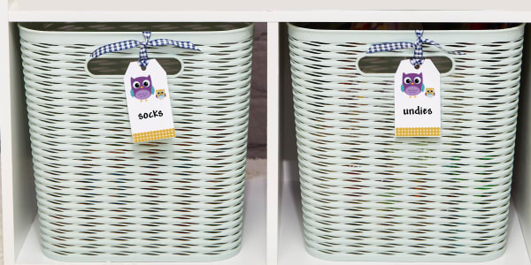 Image shows two bins on a shelf with Avery printable tags. The tag on the left bin says "socks" and the tag on the right bin that says "undies".