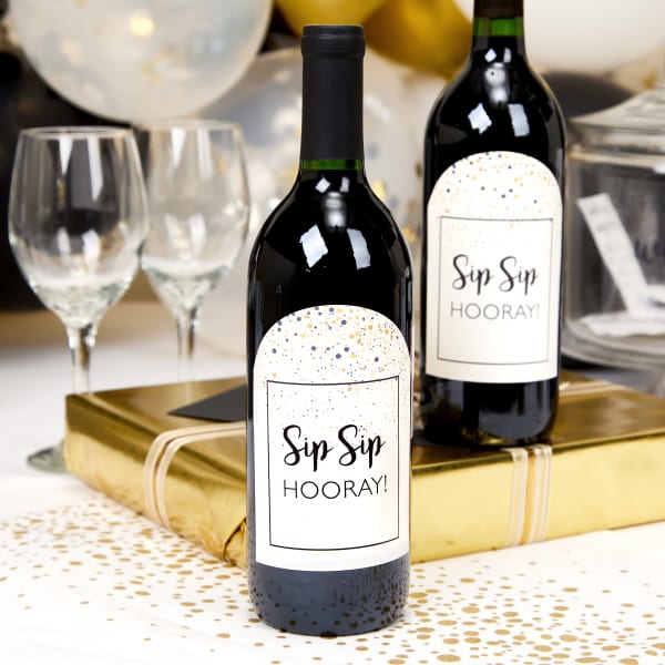 This image showcases a popular party favor idea for adults, which is a bottle of wine personalized with a label for the occasion. The wine bottles in this photo are personalized with Avery 22826 arched labels. 
