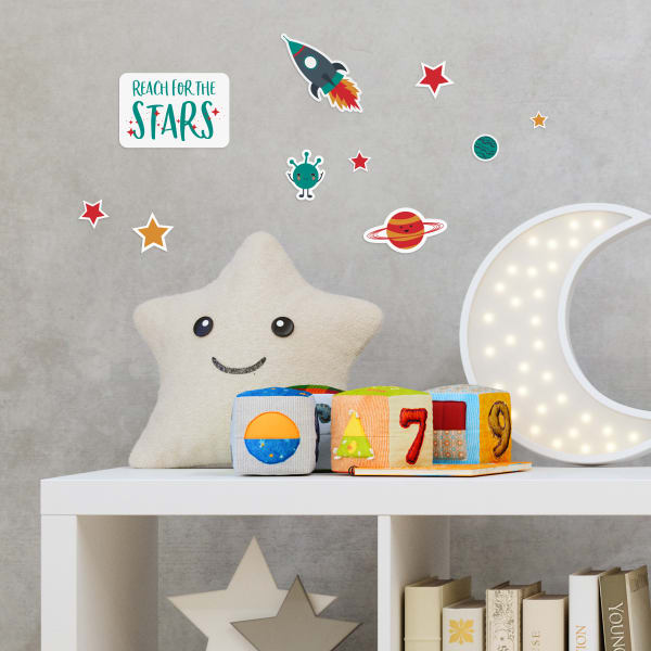 Avery removable decals 61512 used for making stickers to decorate a kids bedroom wall. The stickers in the image are space-themed to complement the room decor.