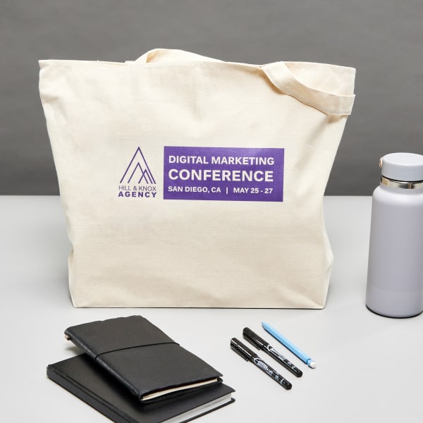 Canvas tote bag with a customized Avery fabric transfer 3271 shown used as a branded  swag bag for a digital marketing conference.