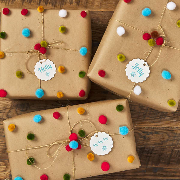 A 3D gift wrapping idea with Avery 80511 tags and colorful pom-poms.