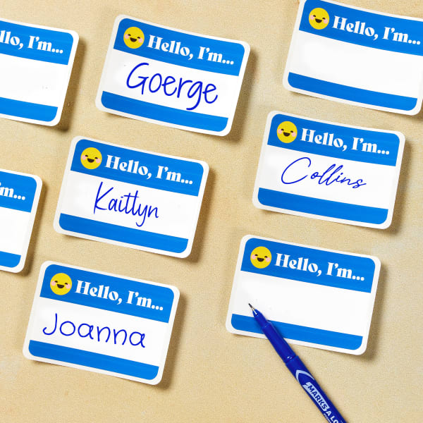 A cool emoji "Hello My Name Is" sticker template. The design features the classic, bold blocks of color, but in a fresh and modern bright blue with the words "Hello, I'm" accented by a friendly emoji face. There is a blank space to write individual names.
