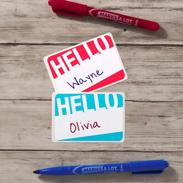  This modern "Hello" sticker design features a twist on the classic by placing the traditional color blocks on a dynamic slant. The text reads "Hello" in big block print and there is white space in the middle to handwrite individual names.