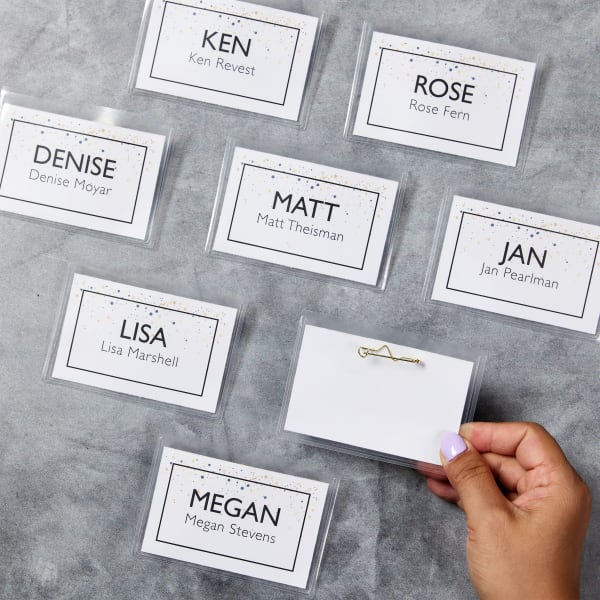 A timeless, classy name tag for parties. The design features a simple border with gold and black "confetti" style accents and bold sans serif font for names that are easy to read.