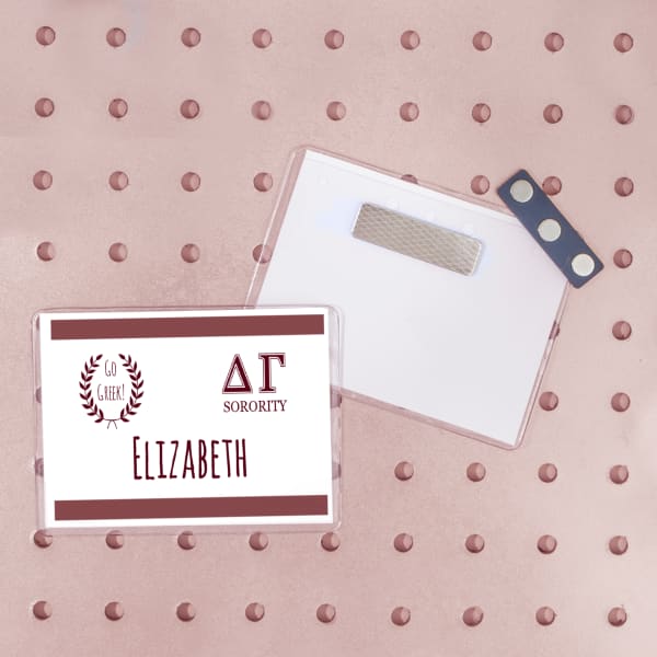 An example of school sorority name badges you can customize. The design features blocks of color and font that can be changed to the sorority colors and a space to type in individual names. The Greek letter graphic can be switched out to match your sorority too. The name badge holder attaches with a magnet so it doesn't damage clothing. 