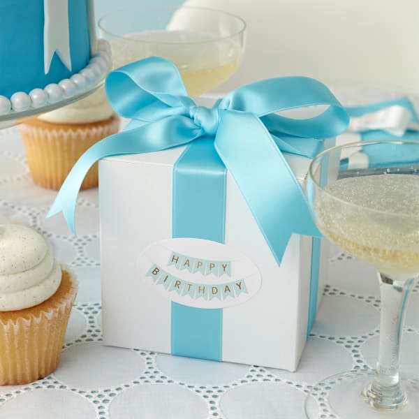 An elegant, upscale, Tiffany-blue birthday theme is accented with favor boxes personalized with Avery label 22820.