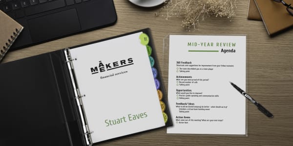 Avery binder 27250 and mid-year review agenda shown on a desk. Employee review documents and paperwork are organized using Avery 8-tab dividers 11201.