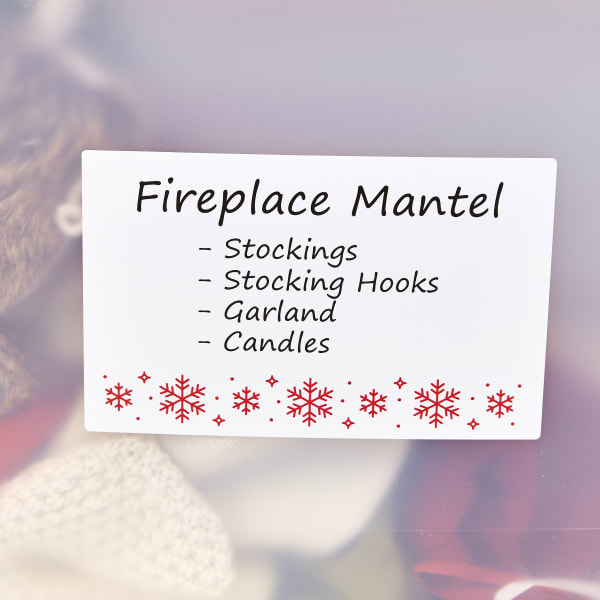A template for large Christmas storage labels that s decorated with red snowflakes. The text reads "Fireplace Mantel" with an itemized list of decorations that are inside the bin. 