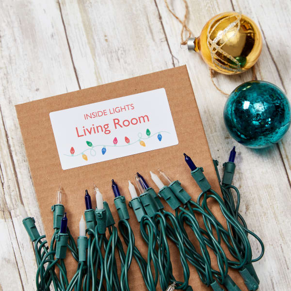 A free Avery template for organizing Christmas lights. The label reads "Inside Lights, Living Room" and is decorated with a cute Christmas lights graphic. 