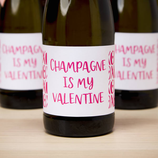 A label that reads, "Champagne is my Valentine" is printed on Avery 92407 blank labels by the sheet and applied to a mini champagne bottle. 