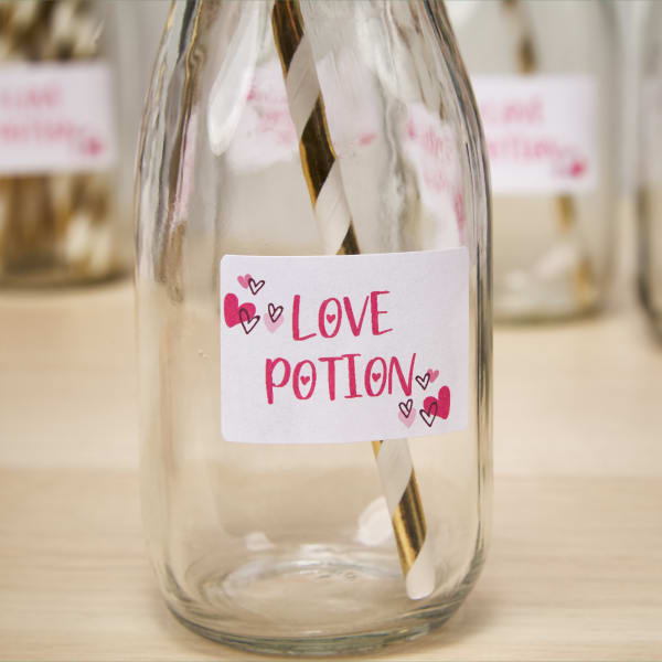 A "love potion" label printed on Avery 22828 and applied to an empty glass jar for Galentine's Day drinks.