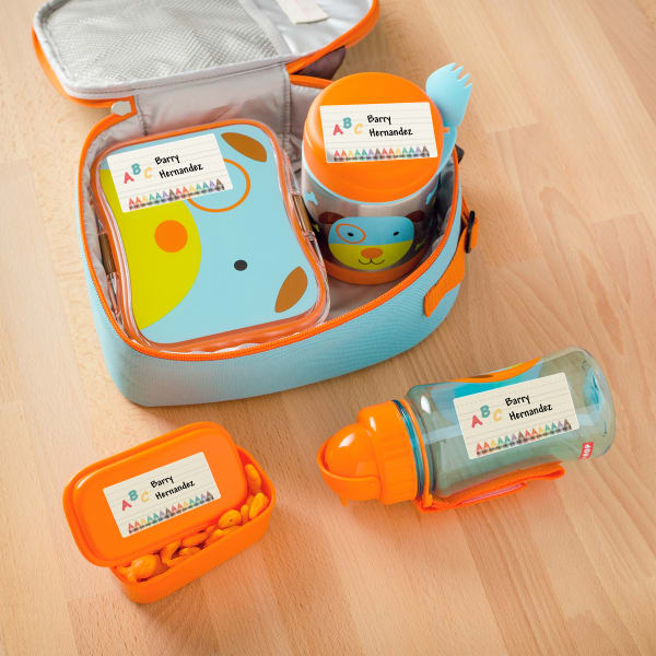 A kid's orange and blue puppy-themed lunchbox set labeled with Avery 1-1/4" x 2-3/8 "waterproof labels sold by the sheet. 