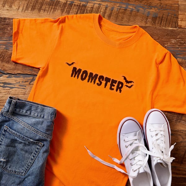 A DIY "Momster" tee shirt idea made with Avery fabric transfer 3302. It features the word "Momster" in classic creepy font accented with black bats. 