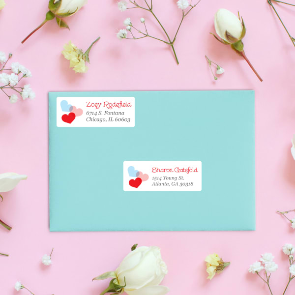 Avery 5160 address labels are shown on an aqua greeting card envelope. The labels features a cute heart theme for Valentine's Day. 