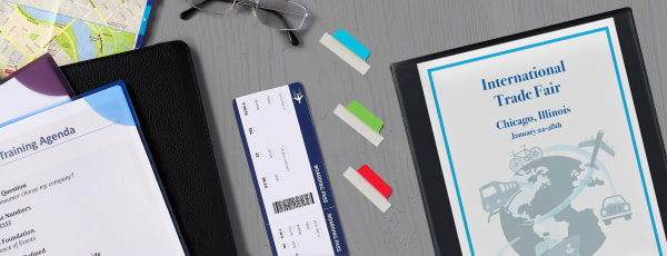 Image showing a travel binder, plane ticket, ultra tabs and business papers in a corner lock folder.