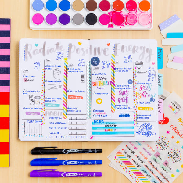 An example of a bullet journal with various Avery planner stickers and tabs used to add color and visual appeal. 