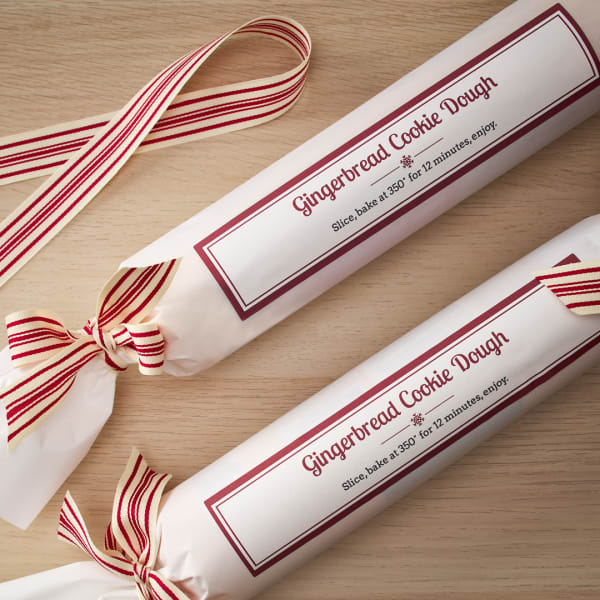 Homemade cookie dough Christmas gift idea is printed on Avery wraparound labels 22838. It reads "Gingerbread Cookie Dough. Slice, bake at 350 degrees for 12 minutes, enjoy."