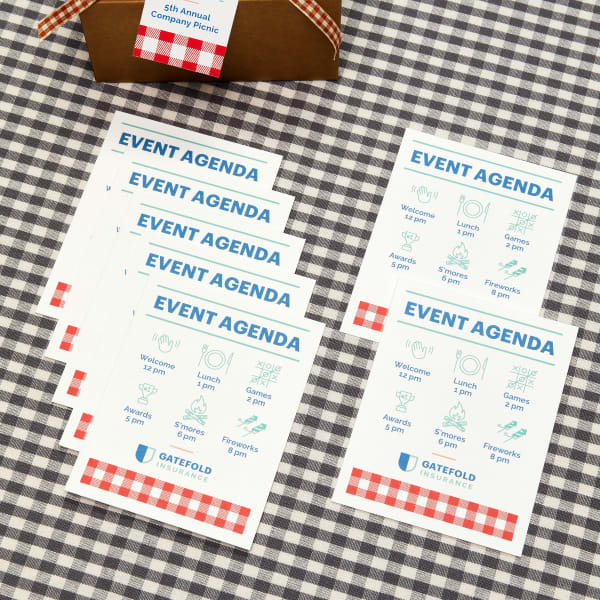 Image showing a stack of company picnic event agendas made from Avery printable postcards and designed using a free Avery template.