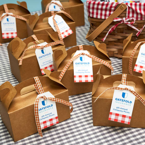 Image showing boxes of treats for a company picnic with an Avery tag tied to each one.
