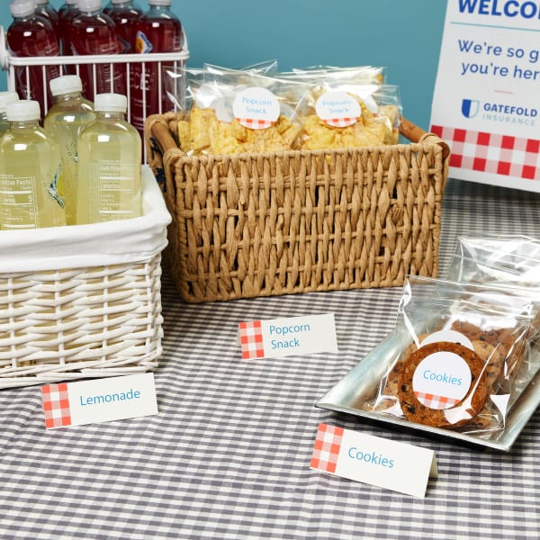 Image showing company picnic table with food, drinks and Avery tent cards displaying what what each snack is.