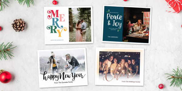 A variety of four different holiday cards featuring Avery templates with space for adding photos shown. The designs are shown on printable Avery notecards and a snowy background with holiday accents.