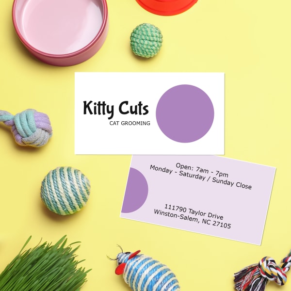 Avery business card 28878 is shown with a design template for a cat-grooming business. The template is a modern take on whimsical featuring a single large polka dot. 