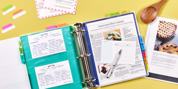A custom recipe binder, organized with Avery ultra tabs and cards, flipped open to a recipe for marinated beet salads.