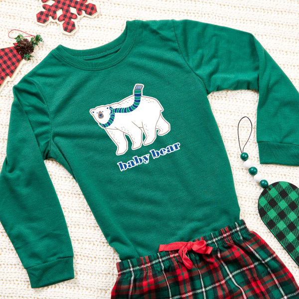 Image showing a green winter-themed pajama set made with Avery fabric transfer that reads “baby bear” under a polar bear cub. 
