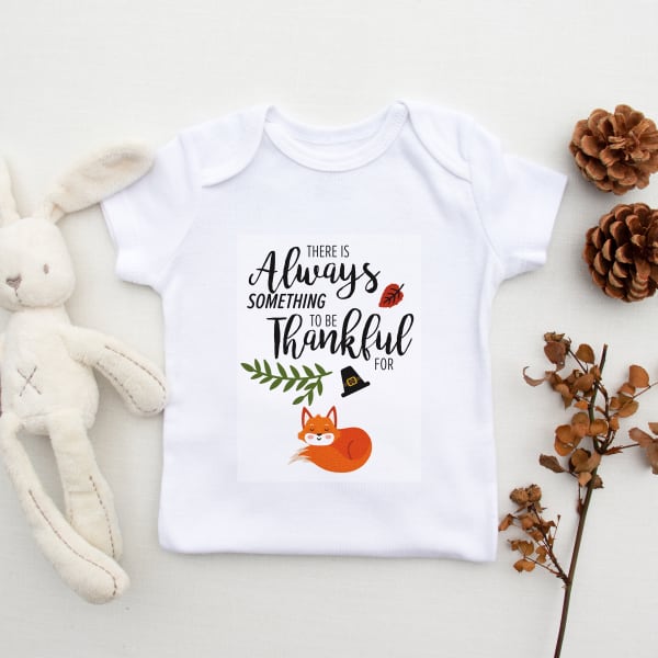 Image showing custom DIY baby onesie with a Thanksgiving template that reads “there’s always something to be thankful for.”