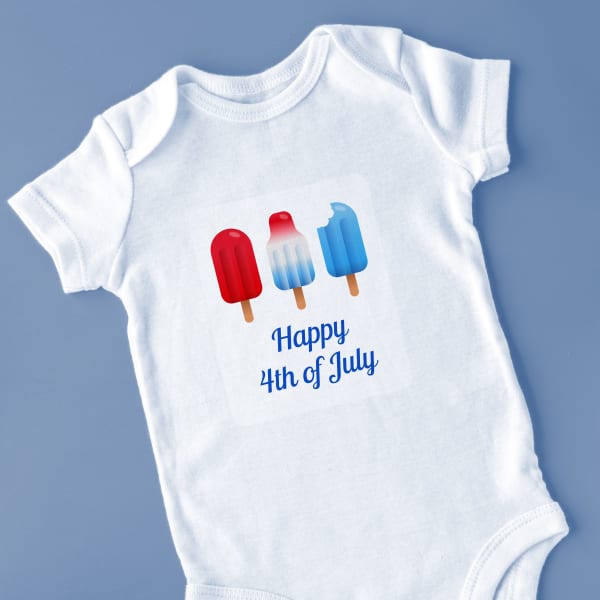 Image showing a baby onesie with a 4th of July template of red, white and blue popsicles and font that reads “Happy 4th of July.”